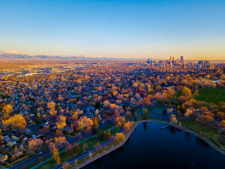 Street view of downtown Denver Colorado, tall buildings and tree lined street