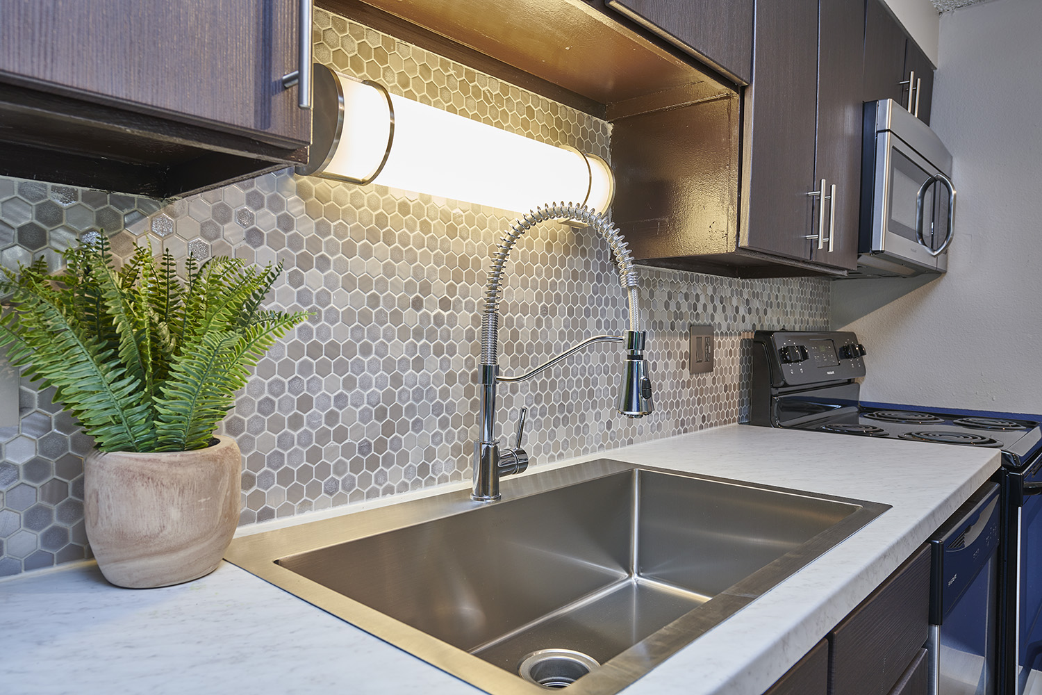 Kitchen with stainless steel appliances and tile backsplash