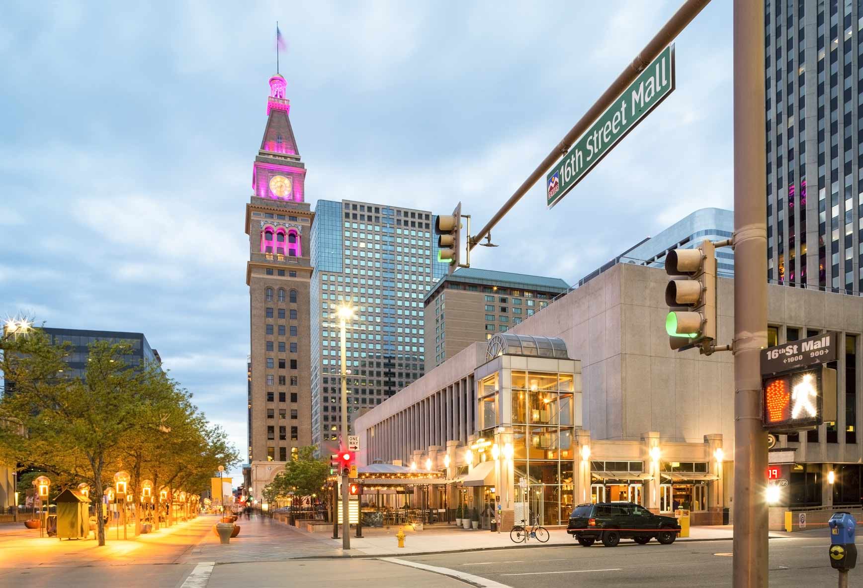 Street view of downtown Denver Colorado, tall buildings and tree lined street