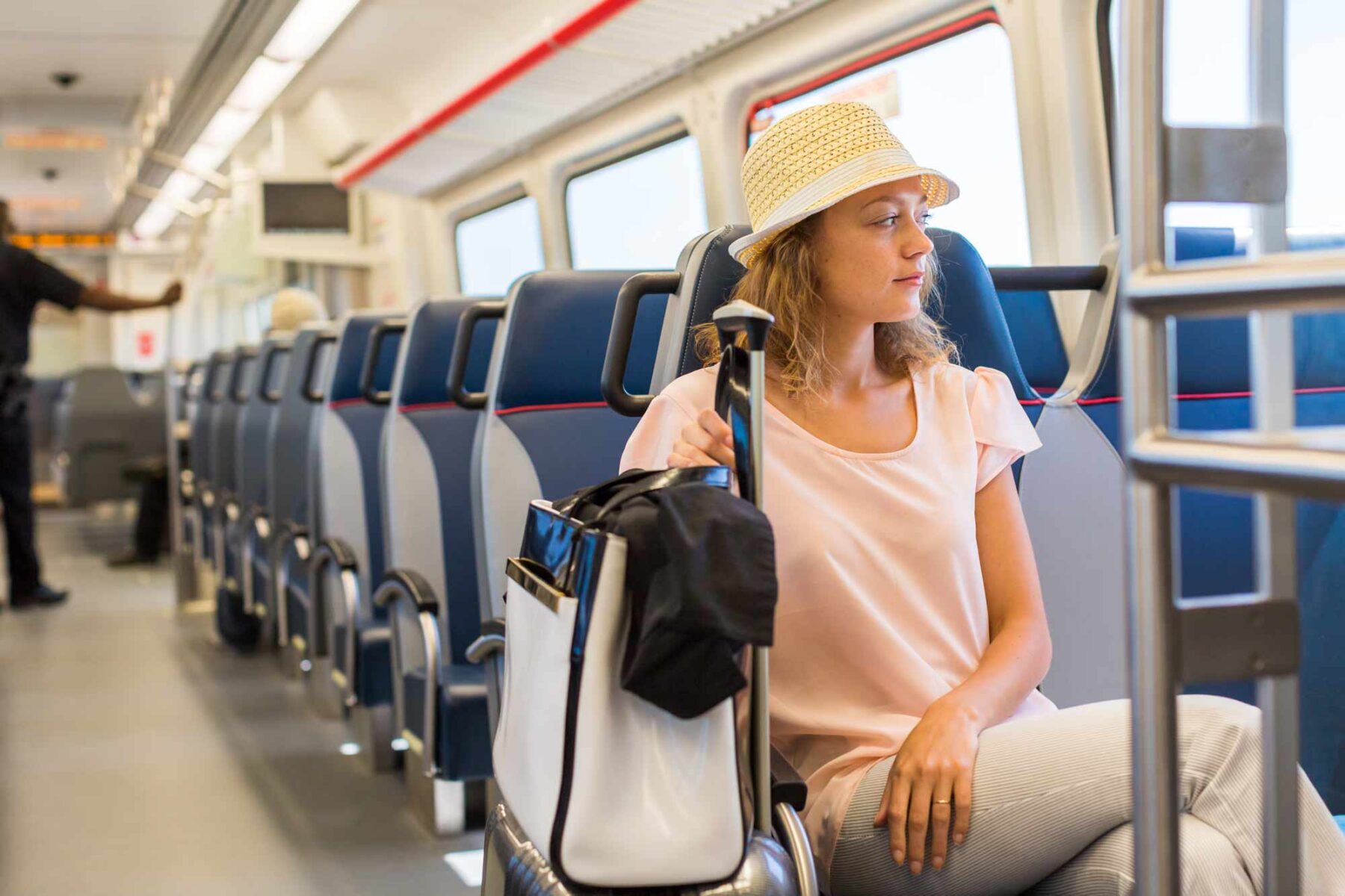 Woman riding a train with a bag