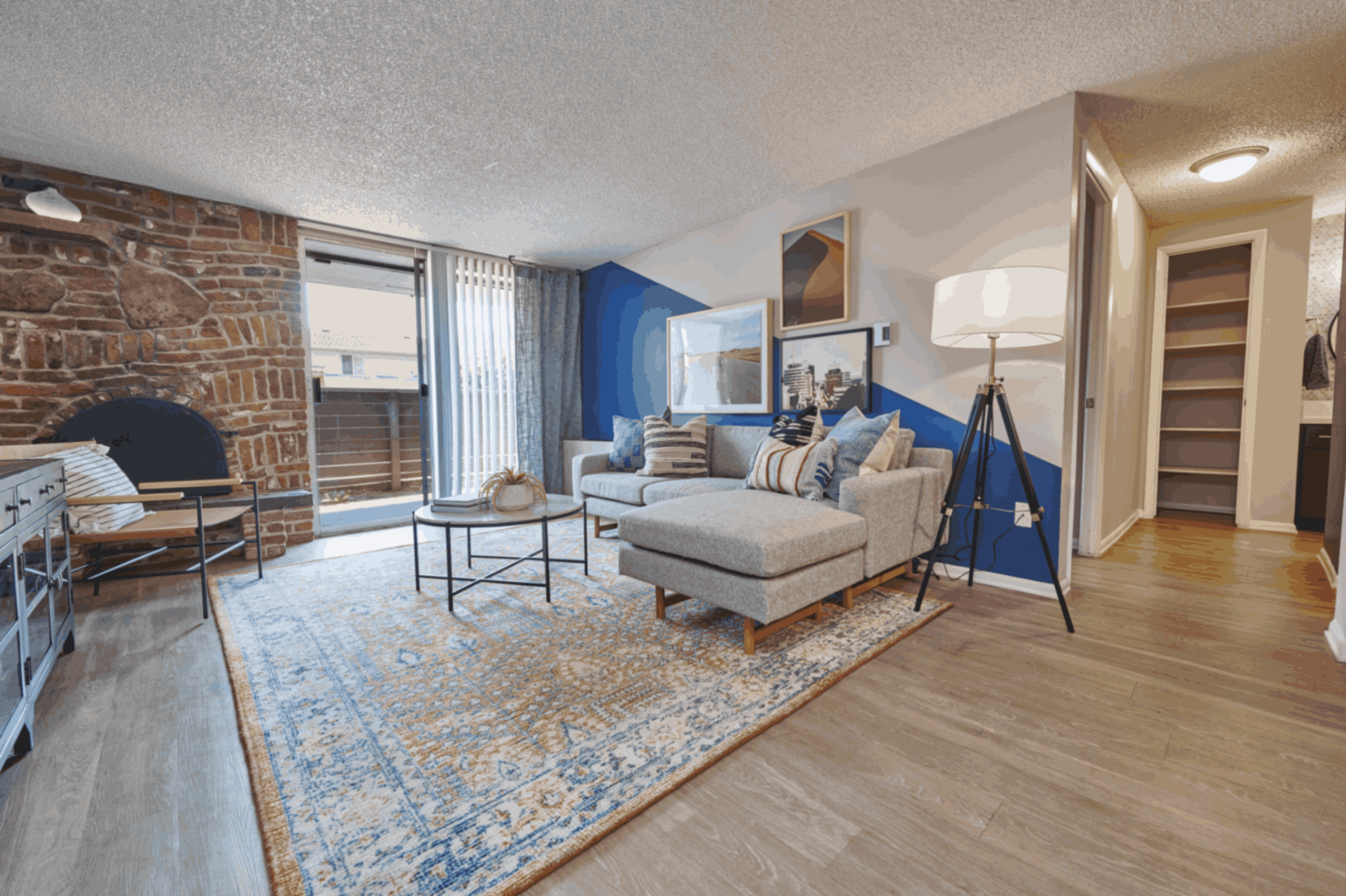 staged living room with brick fire place and patio doors